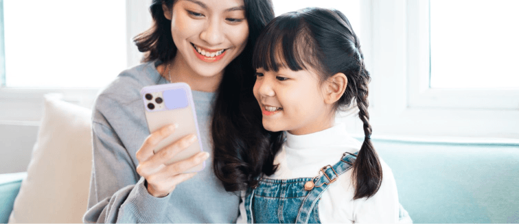 woman and a child looking at a phone